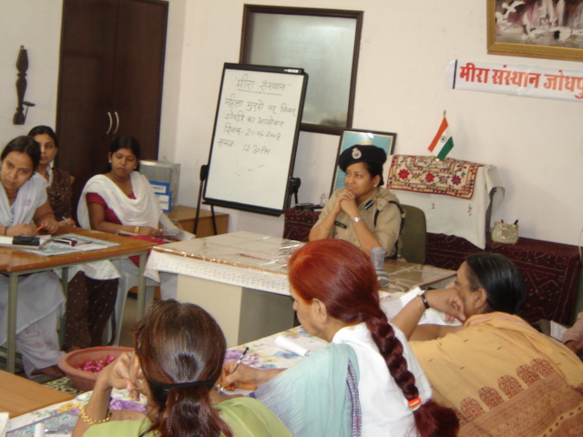 Women counsellors taking notes during a discussion with a police representative