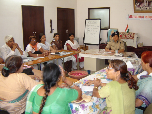 Meera counsellors and police representatives discussing women’s issues around a table