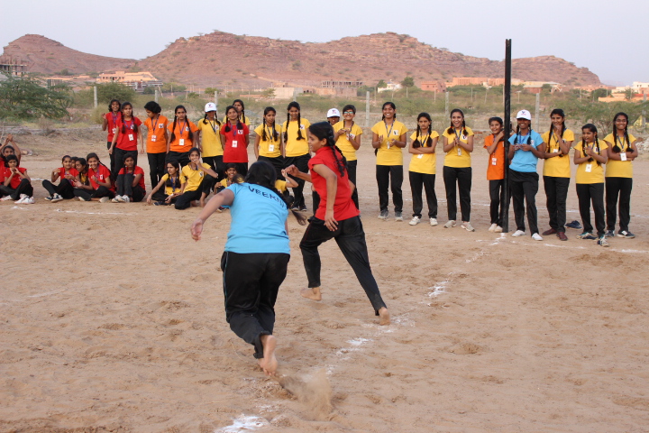 Girls playing together on a school sports ground