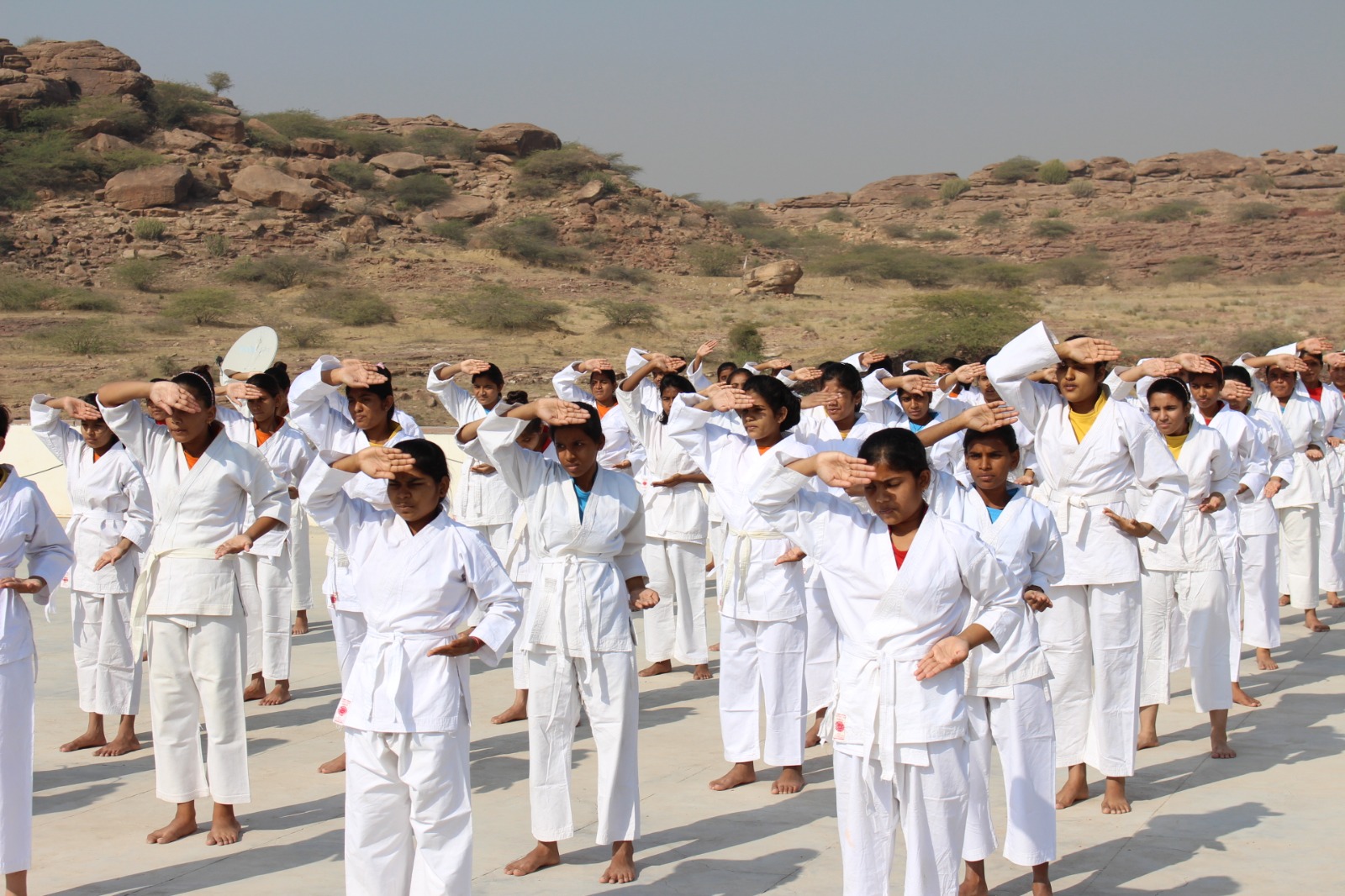 Students in white uniforms participating in a parade