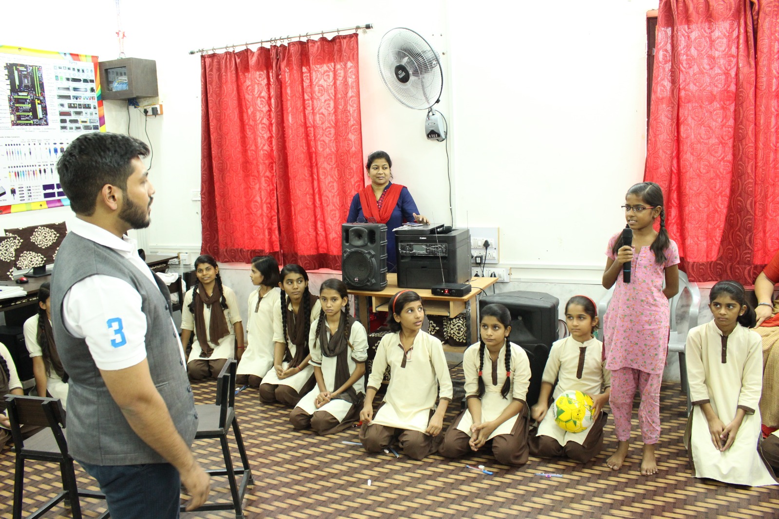 A schoolgirl speaking to other students and programme staff