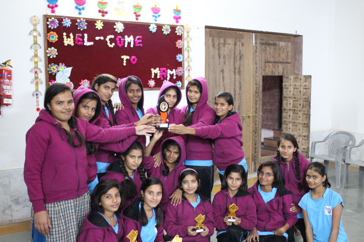 Girls posing together in their school uniforms
