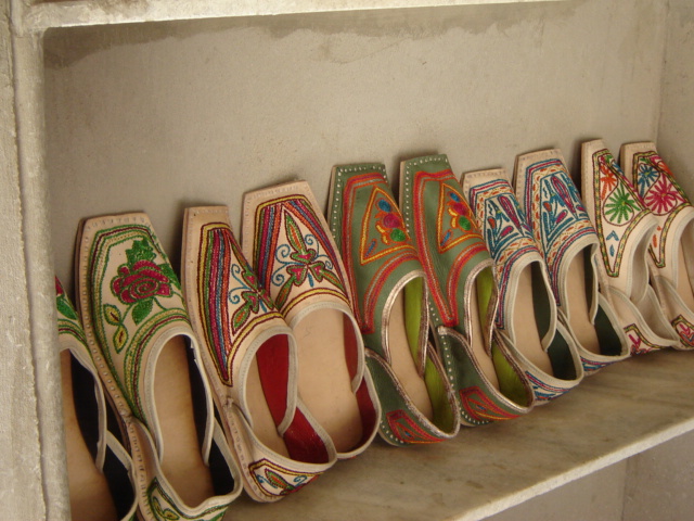Artisan & Leather Cluster: embroidered mojaris display shelf