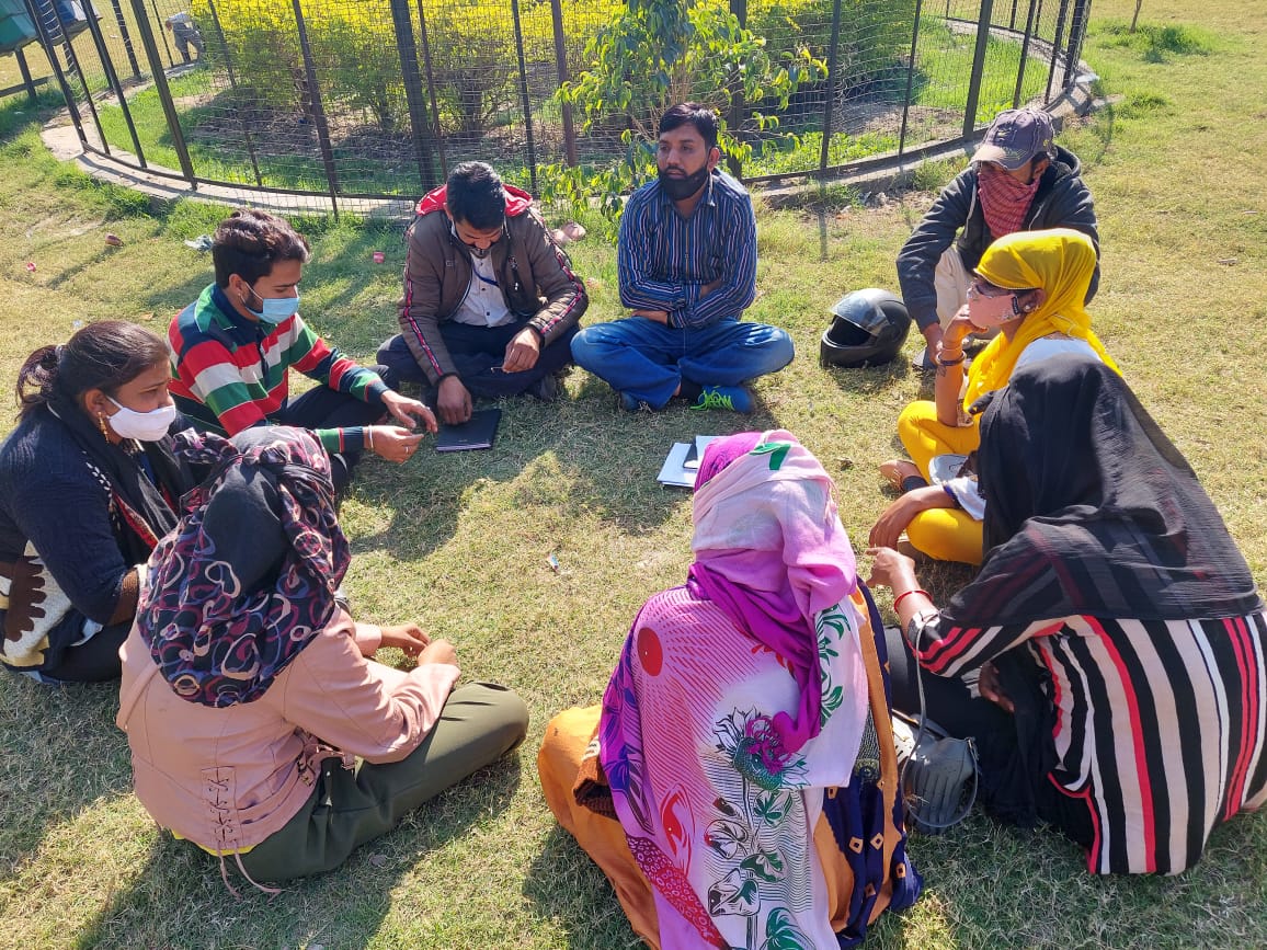 Programme staff and women sitting together in a garden